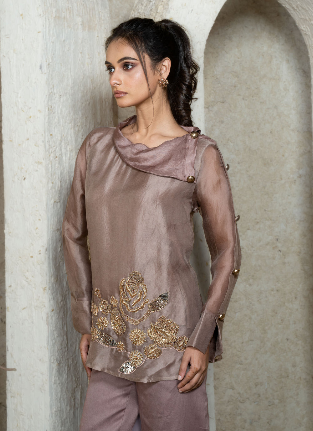 Woman wearing a champagne brown top with zardozi embroidery 